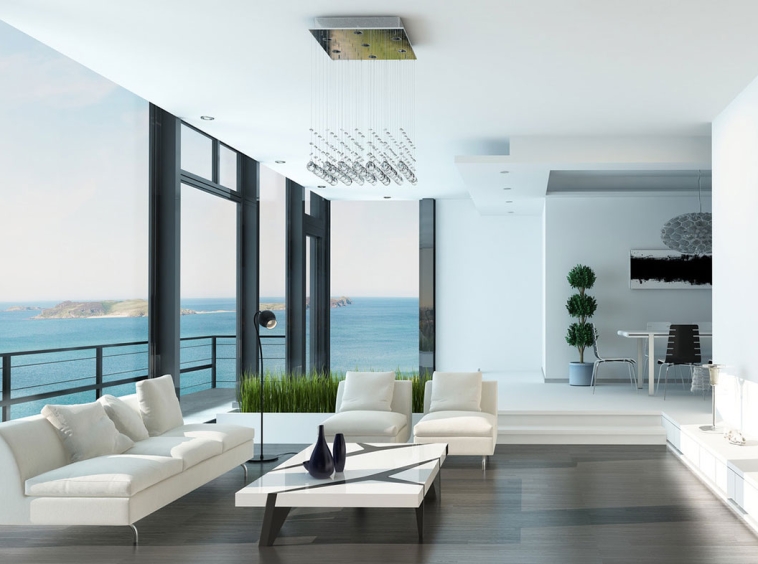 A living room with large windows and a view of the ocean.