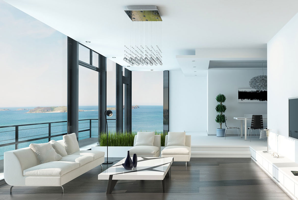 A living room with large windows and a view of the ocean.