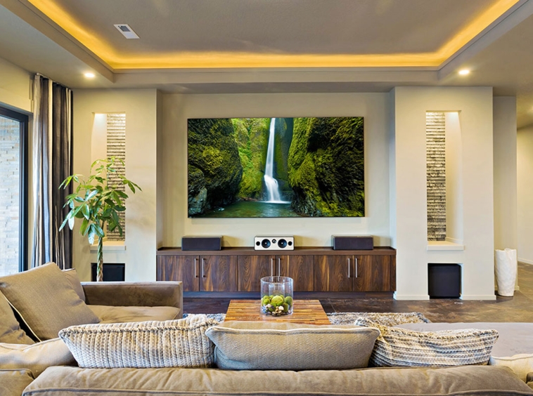 A living room with a large television and speakers