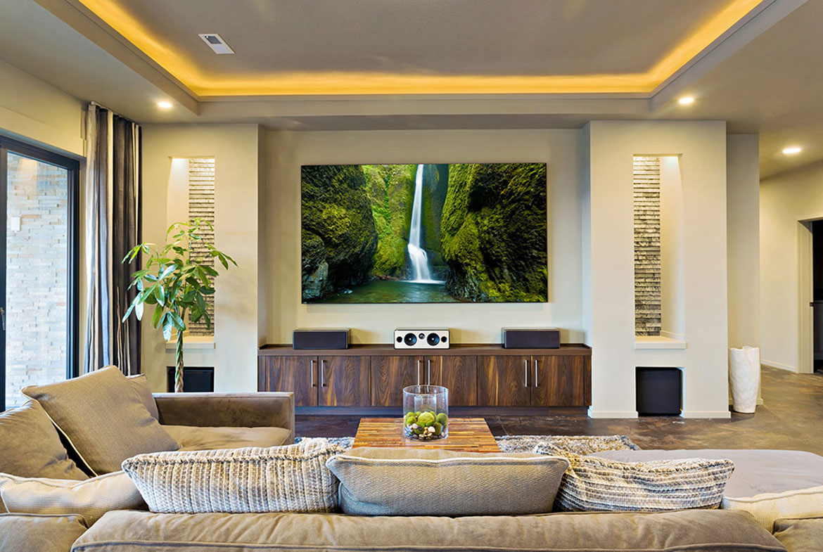 A living room with a large television and speakers