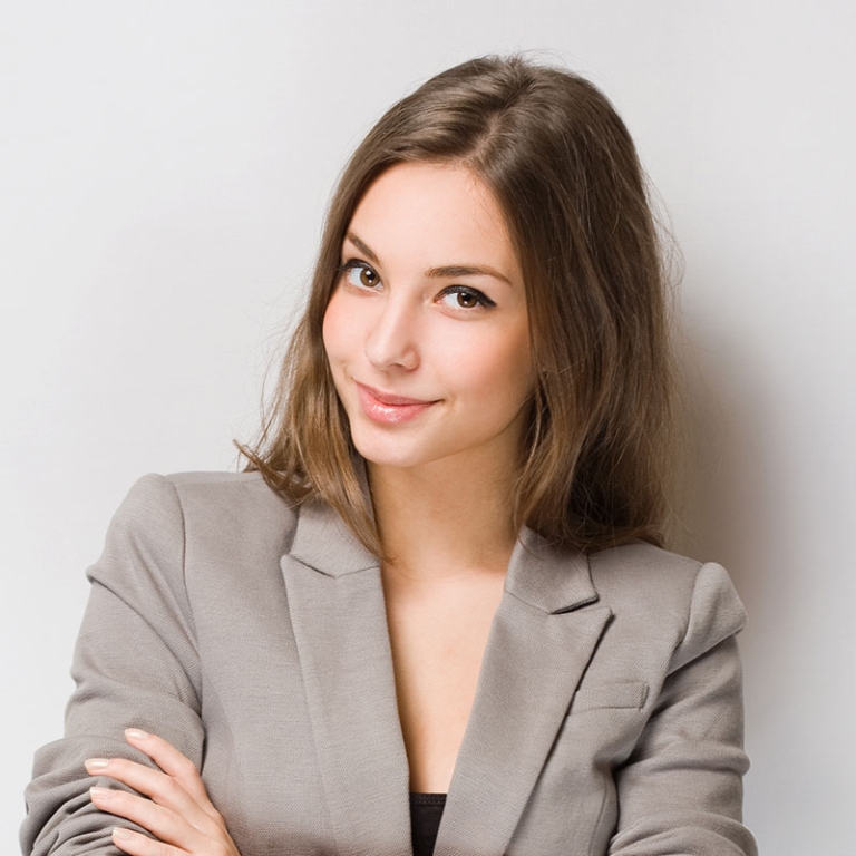 A woman in a gray jacket posing for the camera.