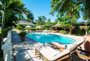 A pool with chairs and umbrellas around it