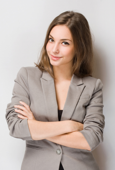 A woman in grey jacket posing for the camera.