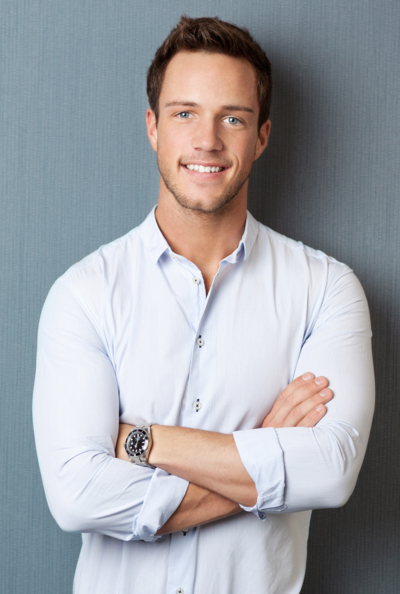 Smiling man in light shirt with folded arms